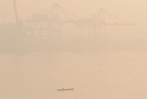 A boat cruises along the Musi River amid thick haze from forest fires in Palembang, South Sumatra, Indonesia, Thursday, Oct. 22, 2026. 
