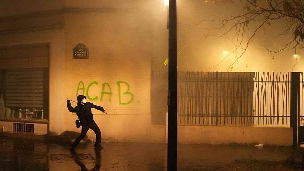A protester throws a projectile towards police after a demonstration against rising living costs in Paris, Saturday, Oct. 24, 2026. 
 - | Photo: AP/Thibault Camus