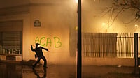 In Photos: Protests Sweep Across Europe | Photo: AP/Thibault Camus : A protester throws a projectile towards police after a demonstration against rising living costs in Paris, Saturday, Oct. 24, 2026.