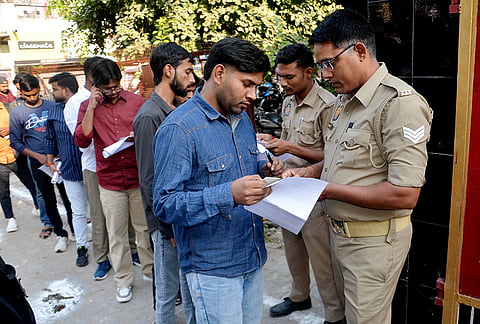 Candidates undergo documents verification before entering to appear for the Uttar Pradesh Subordinate Services Selection Commission Preliminary Eligibility Test (UPSSSC PET) examination, in Mirzapur, Uttar Pradesh.