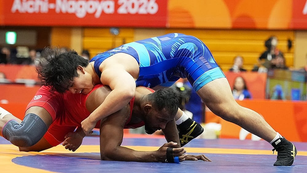 Japan's Yuri Nakazato, top, competes against India's Nitesh during the men's greco-roman 97kg final wrestling match at the Asian Games in Nagoya, Japan, Thursday, Oct. 1, 2026.  - | Photo: AP/Lee Jin-man