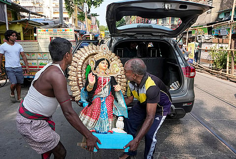 An idol of Goddess Lakshmi being transported to a worship venue on the eve of the 'Kojagari Lakshmi Puja', in Kolkata, West Bengal, Saturday, Oct. 24, 2026. 
