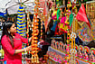 In Photos: Preparations Underway Ahead of Lakshmi Puja | Photo: PTI : A woman looks on at decorative items ahead of Lakshmi Puja festival, in Guwahati, Assam, Saturday, Oct. 24, 2026.