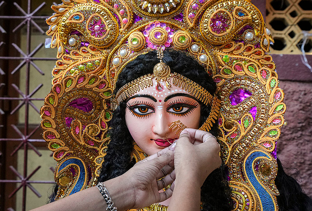 An artist prepares an idol of Goddess Lakshmi
