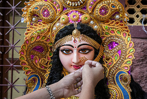 An artist prepares an idol of Goddess Lakshmi ahead of Lakshmi Puja, in Kolkata, Friday, Oct. 23, 2026. 