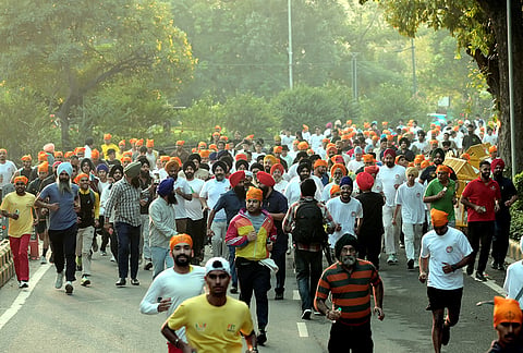 Participants run during a marathon organized by the Delhi Sikh Gurdwara Management Committee ('DSGMC') from India Gate to Gurdwara Rakab Ganj Sahib, in New Delhi.
