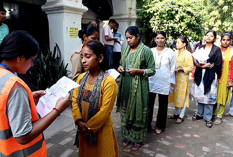 Candidates undergo documents verification before entering to appear for the Uttar Pradesh Subordinate Services Selection Commission Preliminary Eligibility Test (UPSSSC PET) examination, in Prayagraj, Uttar Pradesh.