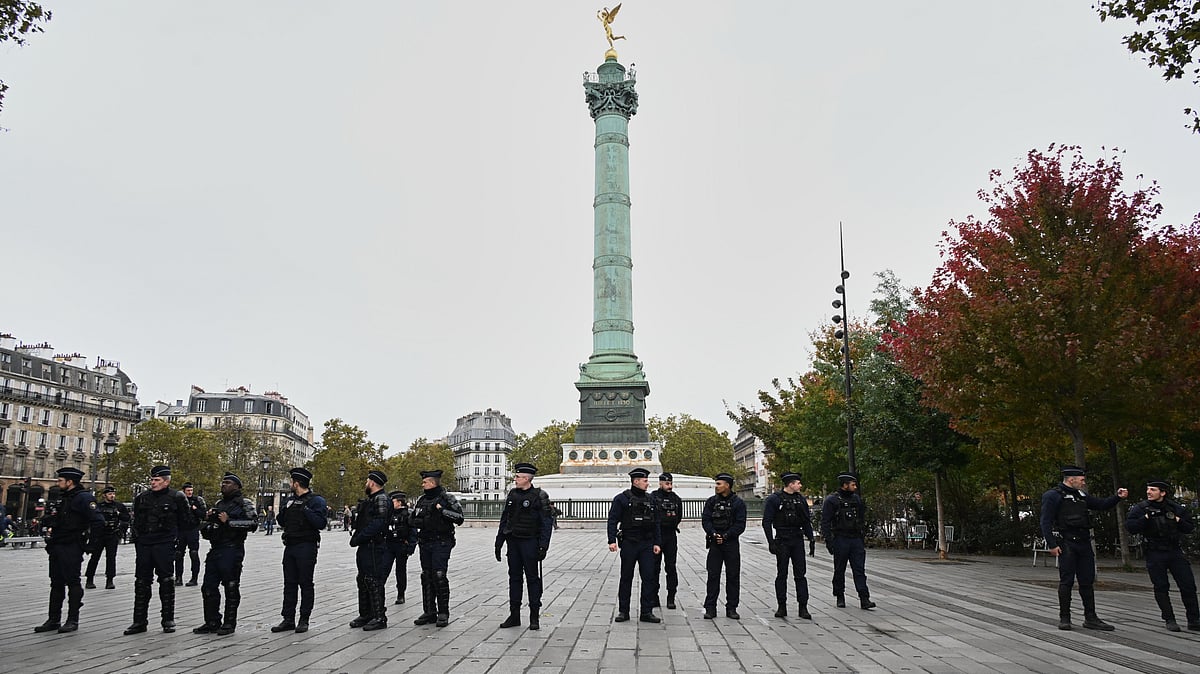Police officers patrol the empty Place de la Bastille ahead of a demonstration against rising living costs in Paris, Saturday, Oct. 24, 2026. - (AP Photo/Emma Da Silva)