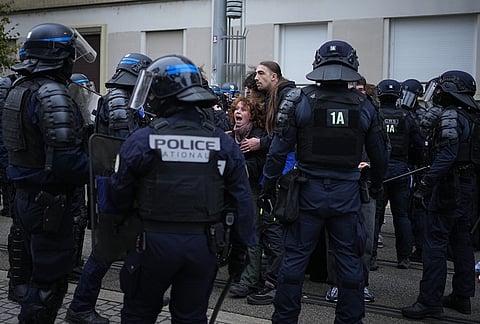 A protester screams at policemen during a demonstration against rising living costs in Lyon, France, Saturday, Oct. 24, 2026. 
