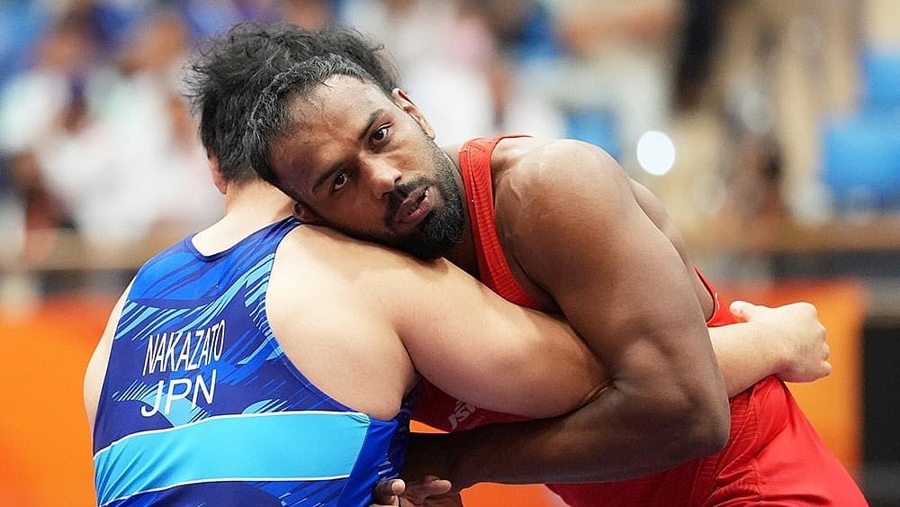 India's Nitesh, right, competes against Japan's Yuri Nakazato during the men's greco-roman 97kg final wrestling match at the Asian Games in Nagoya, Japan, Thursday, Oct. 1, 2026.  - | Photo: AP/Lee Jin-man