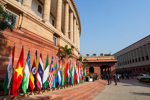 Flags of participating countries displayed outside Parliament House during the BRICS 12th Parliamentary Forum, in New Delhi.