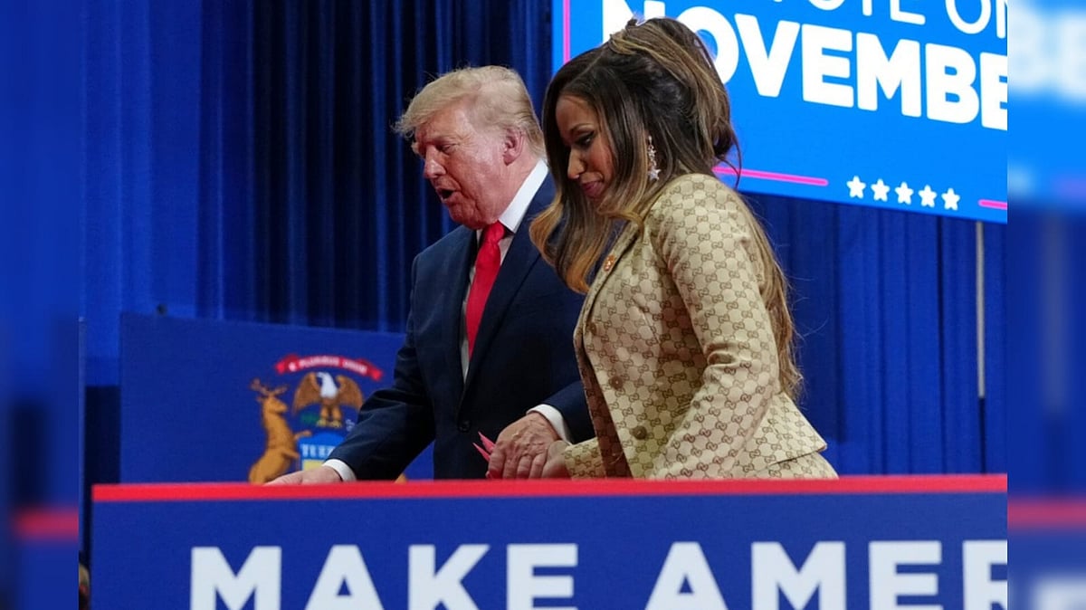 President Donald Trump, left, escorts Nicki Minaj off stage after Minaj spoke during a campaign rally at McMorran Place Sports and Entertainment Center - AP Photo/Julia Demaree Nikhinson