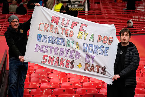 Manchester United supporters hold a banner after their team lost the English Premier League soccer match between Manchester United and Bournemouth in Manchester, England, Sunday, Oct. 25, 2026.