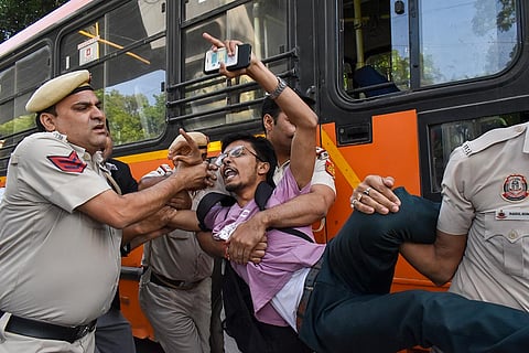 Security personnel detain protesters during a demonstration outside the Jamia Millia Islamia University, in New Delhi, Monday, Oct. 26, 2026. Jamia Millia Islamia on Monday ordered that students' union elections be held within 15 days of the approval of the union's constitution and revoked suspension and show-cause notices issued to students during the ongoing protest, according to an official order.