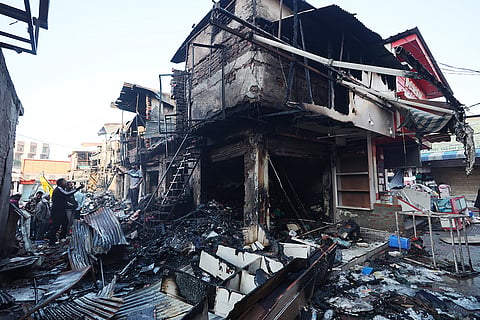 Charred remains and debris lie after a fire broke out at Shiv Market opposite the Jammu Railway Station, in Jammu.
