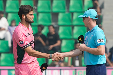Pakistan's Shaheen Shah Afridi, left, shakes hands with England's Harry Brook after a coin toss during the tri-series one-day international cricket match between Pakistan and England, in Lahore, Pakistan, Sunday, Oct. 25, 2026.