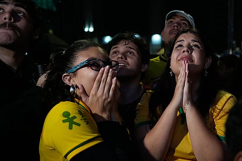 Supporters of opposition presidential candidate Sen. Flavio Bolsonaro react to presidential runoff results in Sao Paulo, Sunday, Oct. 25, 2026.