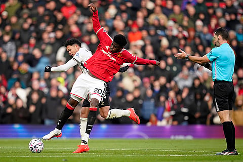 Bournemouth's Evanilson and Manchester United's Carlos Baleba, right challenge for the ball during the English Premier League soccer match between Manchester United and Bournemouth in Manchester, England, Sunday, Oct. 25, 2026.