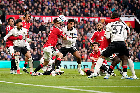 Manchester United's goalkeeper Karl Darlow, center left, and Bournemouth's Tyler Adams challenge for the ball during the English Premier League soccer match between Manchester United and Bournemouth in Manchester, England, Sunday, Oct. 25, 2026.