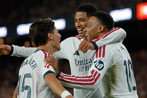 Real Madrid's Kylian Mbappe, right, celebrates with his teammates Arda Guler, left, and Jude Bellingham after scoring his side's opening goal during a Spanish La Liga soccer match between FC Barcelona and Real Madrid in Barcelona, Spain, Sunday, Oct. 25, 2026.