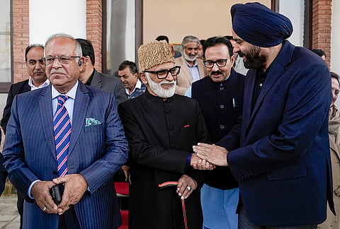 Newly sworn-in Jammu and Kashmir cabinet minister Ali Mohammad Sagar being congratulated during his oath-taking ceremony, in Srinagar.