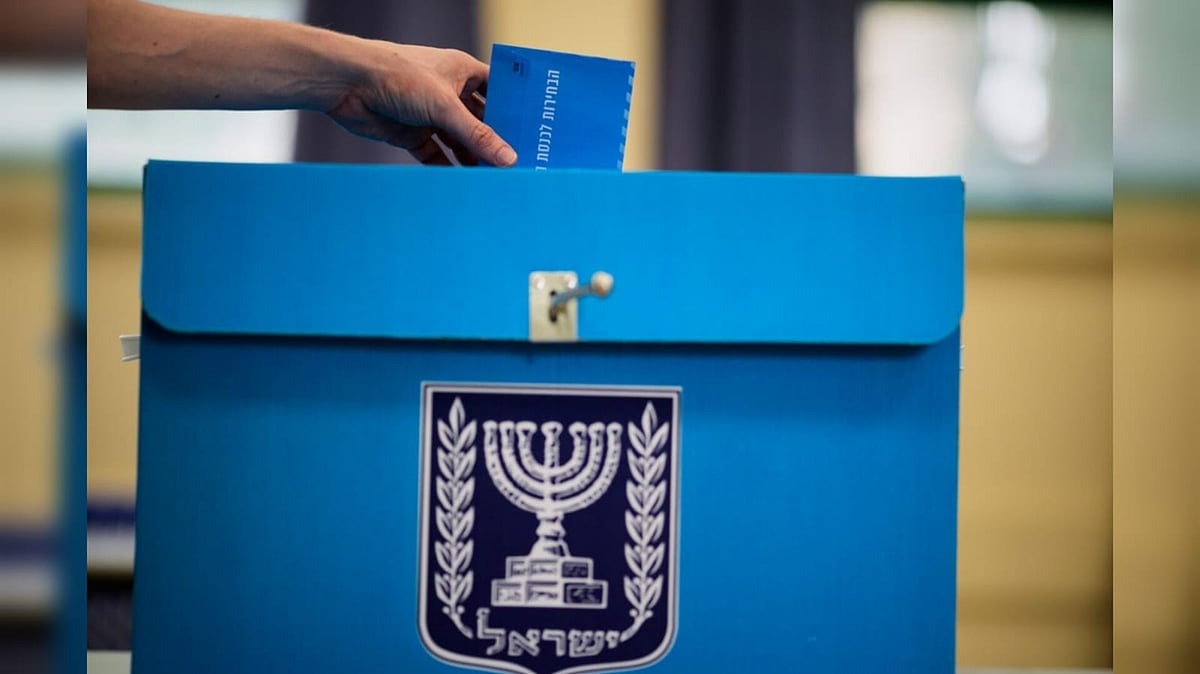 A voter casts his ballot at a school used as a polling station during Israel's general election in Tel Aviv  - AP Photo/David Goldman 