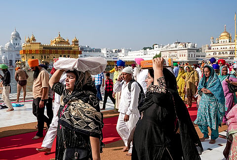 People at the Golden Temple to pay obeisance on the birth anniversary of Guru Ram Das, the fourth Sikh Guru, in Amritsar, Punjab, Tuesday, Oct. 27, 2026. 