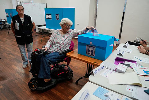 A woman casts her ballot at a polling station during Israel's general election in Haifa, Israel, Tuesday, Oct. 27, 2026. 
