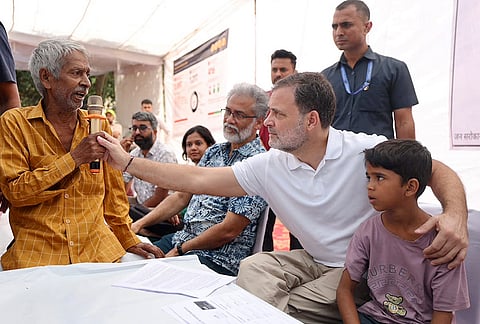Leader of Opposition in the Lok Sabha Rahul Gandhi interacts with local residents during a 'Jansunwai' programme on the Special Intensive Revision (SIR) of electoral rolls, at Trilokpuri, in New Delhi.