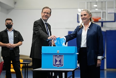 Israeli President Isaac Herzog and his wife Michal Herzog cast their ballots at a polling station during Israel's general election in Jerusalem Tuesday, Oct. 27, 2026. 
