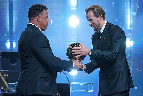 England's soccer player Harry Kane receives the player of the year trophy from Ronaldo Nazario during the Ballon d'Or ceremony at the London Palladium Theatre in London, England, Monday, Oct. 26, 2026.