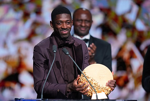 Ousmane Dembele receives the trophy for the best club of the year, Paris Saint-Germain, during the Ballon d'Or ceremony at the London Palladium Theatre in London, England, Monday, Oct. 26, 2026.