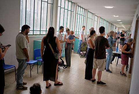 Voters wait in line to cast their ballots at a school used as a polling station during Israel's general election in Tel Aviv, Israel, Tuesday, Oct. 27, 2026. 
