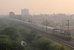 | Photo: PTI  : A train runs on the tracks amid low visibility due to smog, in Gurugram, Haryana.