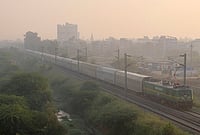 Day In Pics: October 27, 2026 | Photo: PTI : A train runs on the tracks amid low visibility due to smog, in Gurugram, Haryana.