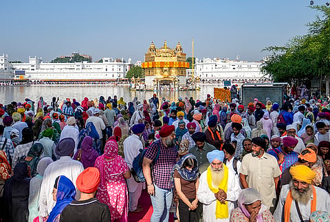 People gather at the Golden Temple to pay obeisance on the birth anniversary of Guru Ram Das, the fourth Sikh Guru, in Amritsar, Punjab, Tuesday, Oct. 27, 2026. 
