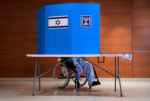 A patient on a wheelchair casts his ballot at a polling station at Rambam Hospital during Israel's general election in Haifa, Israel, Tuesday, Oct. 27, 2026. 
