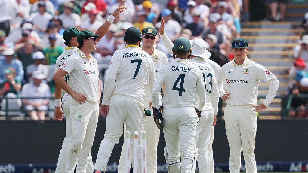 Australian players celebrate the wicket of South Africa's captain Temba Bavuma on day one of the third cricket test match between South Africa and Australia in Cape Town, South Africa. - Halden Krog/AP Photo