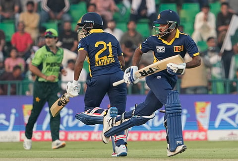 Sri Lanka's Pavan Rathnayake, right, and Kamindu Mendis run between the wickets during the tri-series one-day international cricket match between Pakistan and Sri Lanka, in Lahore, Pakistan, Tuesday, Oct. 27, 2026. 