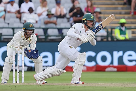 South Africa's Ryan Rickelton, right, plays a shot as Australia's wicketkeeper Alex Carey watches on during day one of the third cricket test match between South Africa and Australia in Cape Town, South Africa, Tuesday, Oct. 27, 2026.