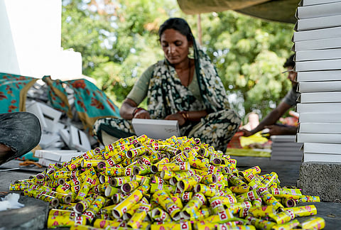 A worker makes firecrackers for sale ahead of the ‘Diwali’ festival, at a factory unit in Ahmedabad, Monday, Oct. 19, 2026. 
