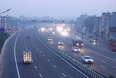 Vehicles ply on the Delhi-Meerut Expressway on a hazy morning, in New Delhi.