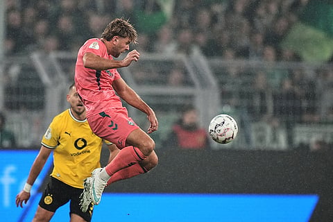 Bremen's Niclas Fuellkrug jumps for the ball during the German soccer cup match between Borussia Dortmund and Werder Bremen in Dortmund, Germany, Tuesday, Oct. 27, 2026.