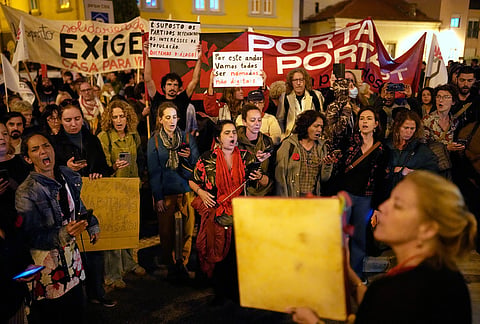 Protesters shout slogans during a demonstration demanding affordable housing outside Portugal's Parliament in Lisbon, Tuesday, Oct. 27, 2026. 