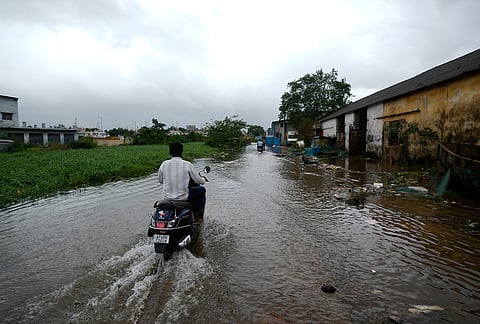 Motorists navigate floodwaters at Kakinada, as Cyclone Arnab crossed the Andhra Pradesh coast in the early hours of Wednesday, Oct. 28, 2026. 