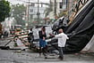 In Photos: Cyclone Arnab Leaves A Trail Of Destruction in Andhra | Photo: AP/Mahesh Kumar A. : A man walks past the destruction caused at Kakinada, after Cyclone Arnab crossed the Andhra Pradesh coast in the early hours of Wednesday, Oct. 28, 2026.