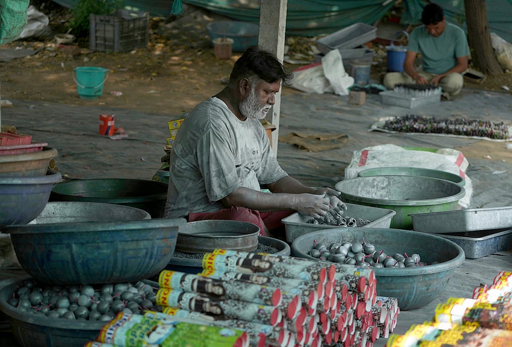 A worker makes firecrackers for the upcoming Hindu festival of Diwali at a factory on the outskirts of Ahmedabad, Tuesday, Oct. 27, 2026. 
 - | Photo: AP/Ajit Solanki