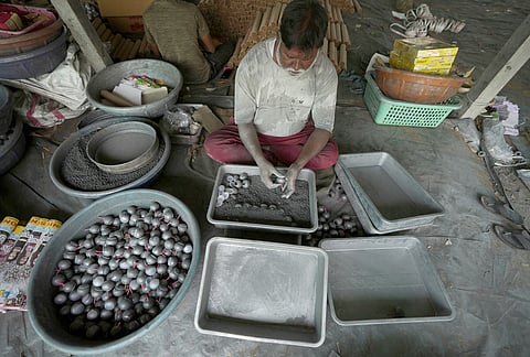 A worker makes firecrackers for the upcoming Hindu festival of Diwali at a factory on the outskirts of Ahmedabad, Tuesday, Oct. 27, 2026. 
