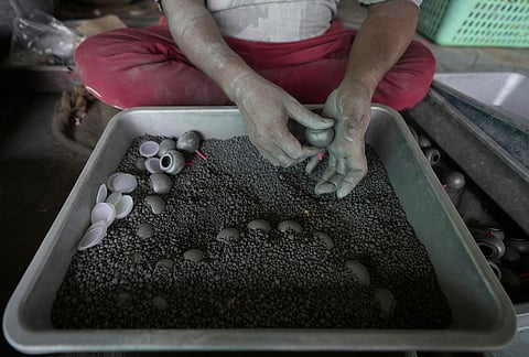 A worker makes firecrackers for the upcoming Hindu festival of Diwali at a factory on the outskirts of Ahmedabad, Tuesday, Oct. 27, 2026. 
