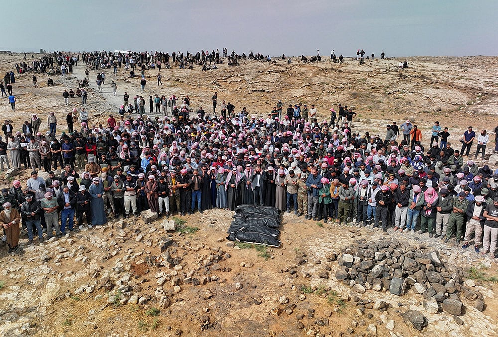 | Photo: AP/Ghaith Alsayed : Mourners pray over the bodies of five members of the same family, including three children, killed in a Jordanian airstrike, which Jordan acknowledged had killed civilians, during the funeral in Al-Tuff in southern Syrias Daraa province, Tuesday, Oct. 27, 2026. 

